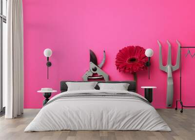 Gardening tools, flower on pink punchy pastel background. Spring, summer or garden concept with copy space. Wall mural