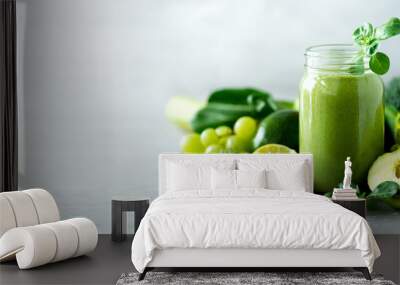 Glass jar mugs with green health smoothie, kale leaves, lime, apple, kiwi, grapes, banana, avocado, lettuce. Copy space. Raw, vegan, vegetarian, alkaline food concept. Banner Wall mural