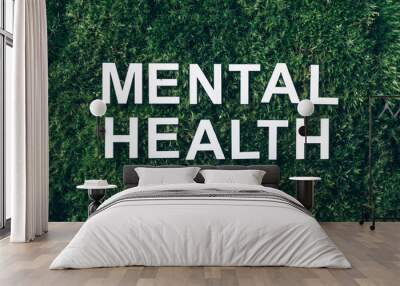 Inscription Mental health on moss, green grass background. Top view. Copy space. Banner. Biophilia concept. Nature backdrop Wall mural