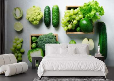 Organic green vegetables and fruits on grey background. Copy space, flat lay, top view. Green apple, lettuce, zucchini, cucumber, avocado, kale, lime, kiwi, grapes, banana, broccoli Wall mural