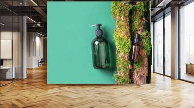 Unlabelled cosmetic bottle on green background, natural moss over branches, bark. Skin care, organic body treatment, spa concept. Vegan eco friendly cosmetology product. Organic cosmetics. Wall mural