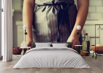 Woman hands cutting fresh green rosemary on wood chopping board in white kitchen, interior. Copy space. Homemade food conceplt, healthy recipe. Take me to work Wall mural