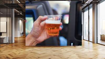 Hand holding  beer in aircraft Wall mural