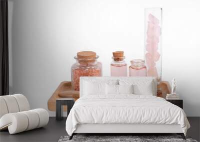 Spa and beauty treatment with rose  liquid soap,pink Himalayan salt and rose quatz stones on wooden tray isolated on white with path Wall mural