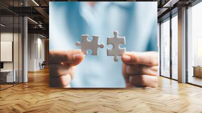 Business woman person hand holding puzzle piece idea for strategy and solution. Closeup part of two white jigsaw connect together. Concept of join cooperation success teamwork-problem corporate team Wall mural