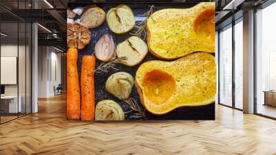 Roasted ingredients for cooking vegetarian creamy pumkin soup consist from carrots, onion, pumpkin squash, eschalot, garlic and rosemary. Vegetable will be  liquidized and mixed with cream and broth. Wall mural