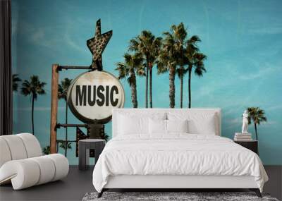 aged and worn vintage photo of music sign and palm trees Wall mural