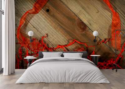 wood background with red ribbon and shreds Wall mural