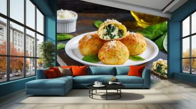 dough balls filled with cheese and spinach on a plate Wall mural