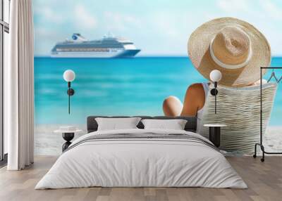 Woman relaxing on tropical shore with a cruise ship in view Wall mural