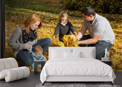 Glückliche junge Familie mit zwei Kindern im Herbst Wall mural