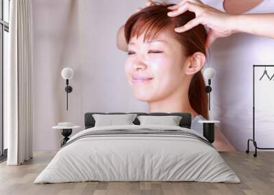 young japanese woman getting a head massage Wall mural