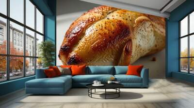 Golden brown roasted chicken leg served on a clean white background Wall mural