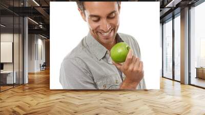 Apple, healthy diet and happy man with food, nutrition and isolated on a white background in studio. Hungry person eating fresh green fruit, vegan and wellness benefits, vitamin c or organic detox Wall mural