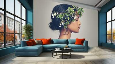 Beauty and nature combined. Studio shot of a beautiful young woman wearing a head wreath. Wall mural