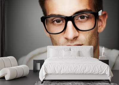 Closeup, portrait and man with glasses in studio for eye care mock up on gray background in Spain. Male model, person and vision with facial expression for spectacles by correction, lens or sight Wall mural