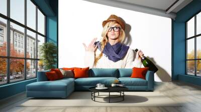 Woman, blonde and hat with champagne of nerd, geek or hipster thinking against a studio background. Attractive female person with glasses, nerdy or fashion style gesture and holding bottle of alcohol Wall mural