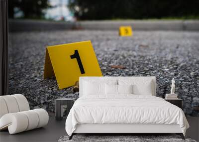 A group of yellow crime scene evidence markers on the street after a gun shooting brass bullet shell casing rifle Wall mural