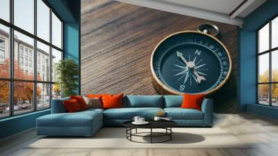 One gold compass on top of a wooden desk Wall mural