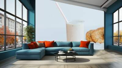 Vertical of the fresh milkshake with cookies isolated on the empty white background Wall mural