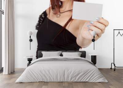 Confident Woman With Red Hair holds up a blank business card. Wall mural