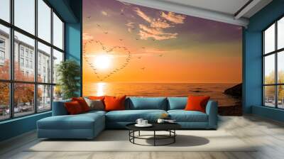 silhouettes of birds. heart at sunset, on the sea. Wall mural