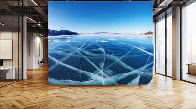 A stunning view of a frozen lake with transparent blue ice and sharp cracks in a mountainous setting. Generative AI Wall mural