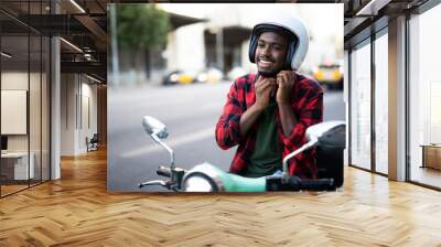 African man with scooter in the city. Young man riding a scooter... Wall mural