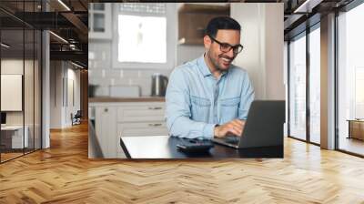 Businessman working on laptop at home. Wall mural