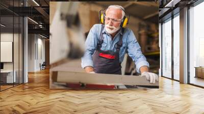 Close up of a carpenter using circular saw machine Wall mural