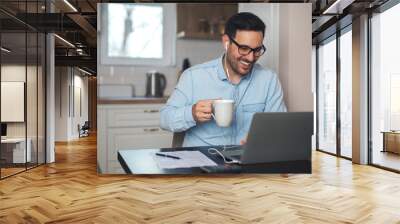 Man having video call on laptop Wall mural