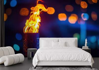 olympic torch with vibrant flame blurred sports arena background symbolic lighting ceremony dramatic contrast Wall mural