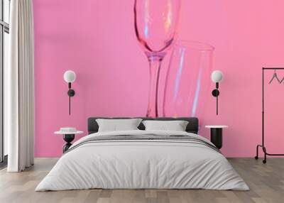 two glasses of champagne with neon pink lights. modern futurism 2022 year background. minimalism. surrealism. creative decoration idea Wall mural