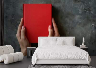 womans hands holding book with blank red cover education and selflearning concept Wall mural