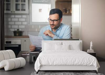 Young man working from home. Wall mural