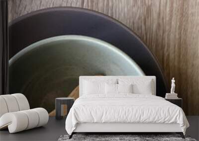 Two ceramic bowls and two wooden spoons on a table. Flat lay.  Wall mural