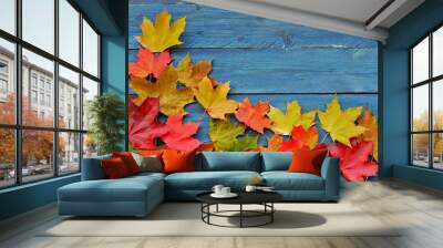 Color maple leaves on blue wooden background Wall mural