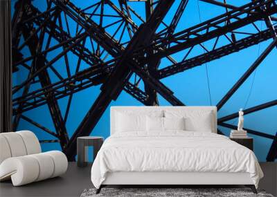 Industrial steel metal tower with beams on blue background Wall mural