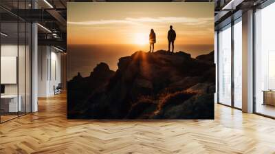 Silhouette of two people standing on mountain peak at sunset generated by AI Wall mural