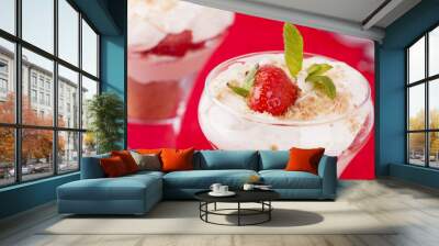 Two strawberry and cream desserts on red background Wall mural