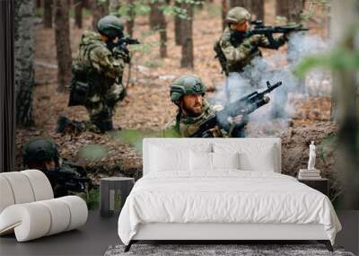 Soldiers in a combat situation. Men play airsoft. Wall mural