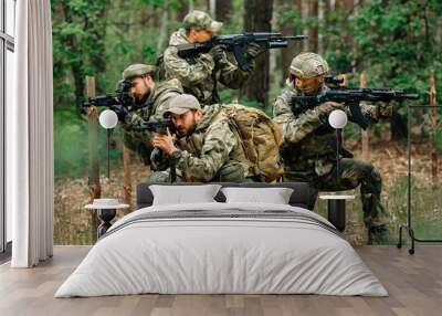 Soldiers in a combat situation. Men play airsoft. Wall mural