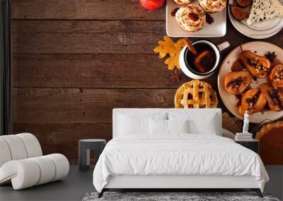 Autumn food side border. Table scene with a selection of pies, appetizers and desserts. Top view over a rustic wood background. Copy space. Wall mural