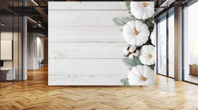 autumn side border of white pumpkins and silver leaves over a rustic white wood background Wall mural