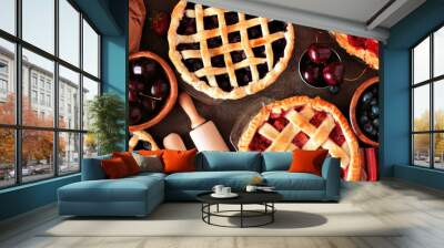 Baking scene with a variety of homemade fruit pies. Top view over a wood banner background. Wall mural