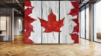 Canadian flag made of red maple leaves over a weathered white wood background Wall mural