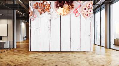 Christmas cookie top border. Above view table scene over a white wood background with copy space. Holiday baking concept. Wall mural