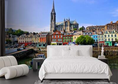 Colorful buildings and old boats with cathedral in background in the harbor of Cobh, County Cork, Ireland Wall mural