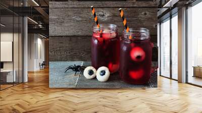 Creepy Halloween eyeball fruit punch in mason jars against an old wood background Wall mural