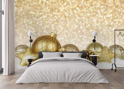 Gold Christmas ornament border in snow with gold background Wall mural